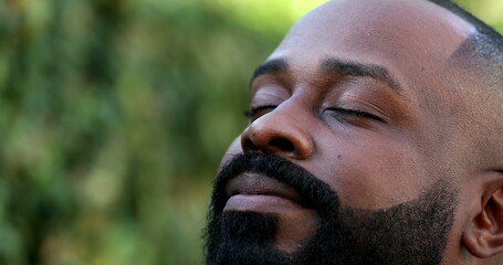 Positive African breathing fresh air outside, happy close-up face smiling-1