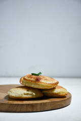 Kue Khamir or samir or Khamir cake on wooden plate. Khamir cake is a traditional snack from Pemalang, Indonesia. This cake is made from flour, butter and egg dough. Selective Focus