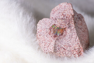 An Opal gemstone embedded in a rock