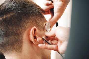 Barber shaving bearded man with retro knife