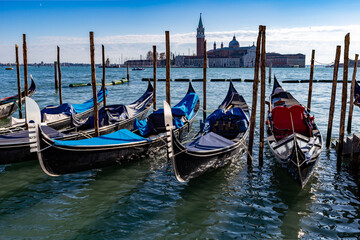 Fototapeta na wymiar Venice, its characteristic architecture and gondolas, which enrich its magnificent scenery, and view of the church of San Giorgio Maggiore