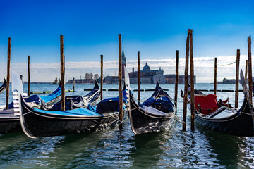 Fototapeta na wymiar Venice, its characteristic architecture and gondolas, which enrich its magnificent scenery, and view of the church of San Giorgio Maggiore