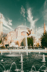 Hagia Sophia -Ayasofya museum and fountain view from the Sultan Ahmet Park in Istanbul, Turkey.  It is in use as a church, mosque and museum.