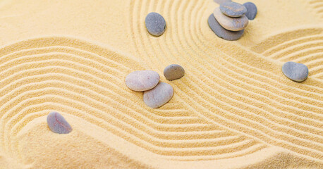 Fototapeta na wymiar Background with stones on the sand. Selective focus.
