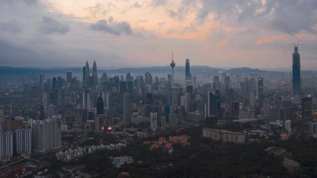 Aerial High Angle Time lapse view of  busy city streets and golden sunrise against a skyline in Kuala Lumpur, Malaysia. Zoom out motion timelapse. Prores 4KUHD.