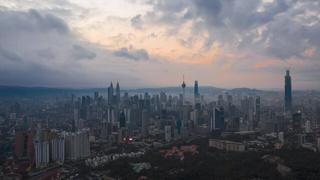 Aerial High Angle Time lapse view of  busy city streets and golden sunrise against a skyline in Kuala Lumpur, Malaysia. Tilt down motion timelapse. Prores 4KUHD.