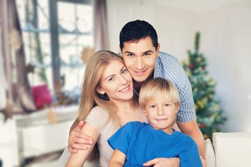 Happy young parents with cute child at home