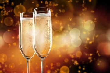 Two glasses of champagne with glitter lights bokeh background