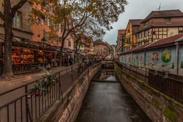Colmar France. Christmas decorations and market. Ornaments on the bridge. Old houses near the canal.