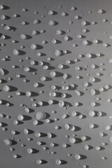 Fototapeta premium Drops on the white surface in close up 