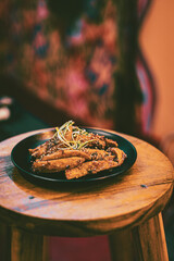 Sweet and sour crispy fried potatoes on a plate at a restaurant