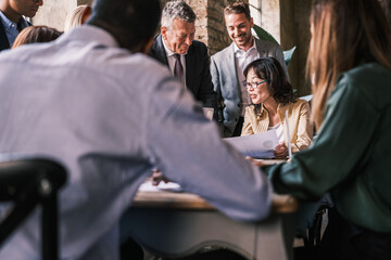 Group of workers gathered to analyze the evolution graphs of the company