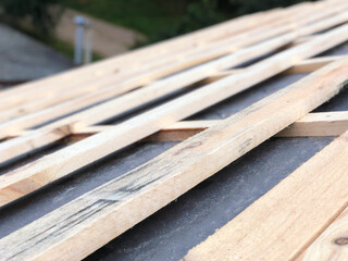 Roofing battens made of wooden bars and slats on the roof close-up