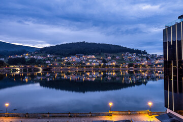 Nightview of Viveiro with river and dwelling houses. Lugo, Galicia, Spain
