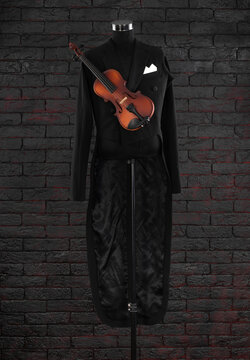 violinist black tailcoat on a black background