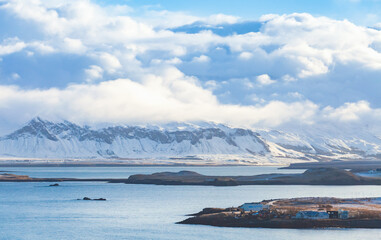 Fototapeta na wymiar Landscape photo of Reykjavik bay with snowy coastal mountains