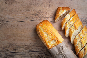 Sliced bread on a brown table. Top view with copy space