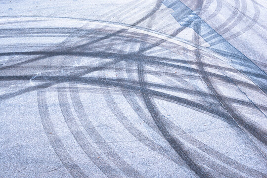 Slippery road, car tracks on the frozen street, black ice in winter