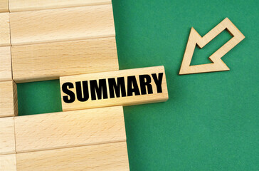 On the green surface are wooden plates and an arrow that points to a plate with the inscription -...