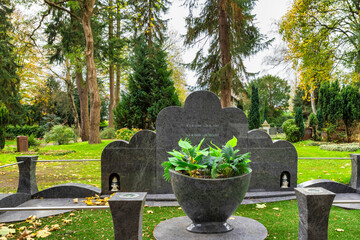 großes Familiengrab mit einer großen Pflanzschale  auf einem Friedhof in Hamburg