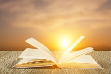 Old open book on wooden desk