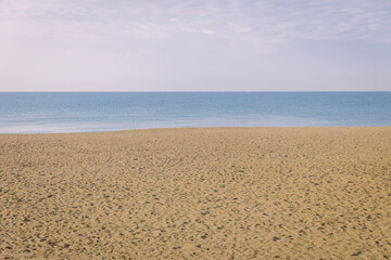 Calm natural background, sea sand and sky in dusty morning