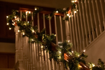 Garland and lights wrapped around handrail on stairs for Christmas 