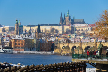 Obraz premium Snowy Prague Lesser Town with Prague Castle above River Vltava in the sunny Day , Czech republic
