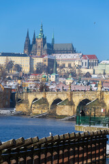 Fototapeta premium Snowy Prague Lesser Town with Prague Castle above River Vltava in the sunny Day , Czech republic