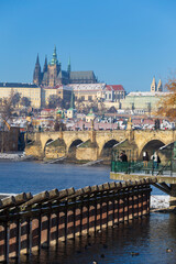 Snowy Prague Lesser Town with Prague Castle above River Vltava in the sunny Day , Czech republic