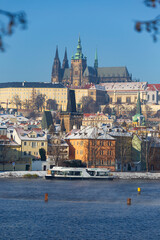 Fototapeta na wymiar Snowy Prague Lesser Town with Prague Castle above River Vltava in the sunny Day , Czech republic