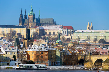 Fototapeta premium Snowy Prague Lesser Town with Prague Castle above River Vltava in the sunny Day , Czech republic
