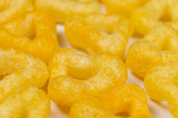 Fototapeta na wymiar Delicious crispy corn chips triangular shape with spices, macro.