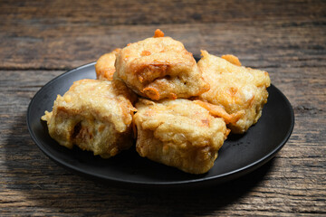 Gorengan or Fried tofu on a black plate. Fried food is one of the favorite snacks in Indonesia and chinna