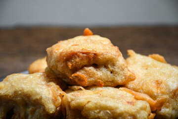 Closeup Gorengan or Fried tofu on a white plate. Fried food is one of the favorite snacks in Indonesia