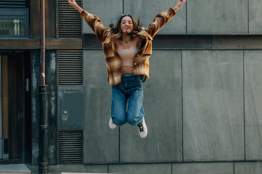Euphoric Girl Jumping Happy On The Street