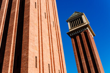 Two Venetian towers in Barcelona, made of exposed brick, built during the universal exhibition of...