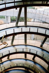 Fototapeta premium Vertical view of large modern spiral staircases with French windows.