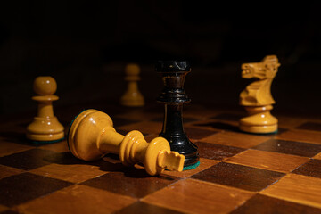 Close up chess checkmate, Black Queen defeats White King