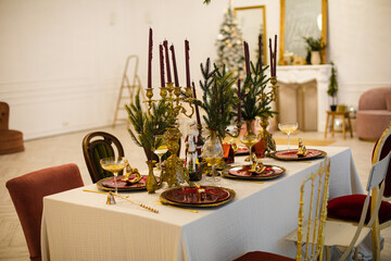 The concept of table setting for the Christmas holidays. A beautiful and stylish decorated table is waiting for guests for the holiday.