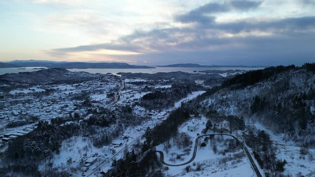 Sunset over Norwegian coastal landscape. Winter, mountains and fjord.