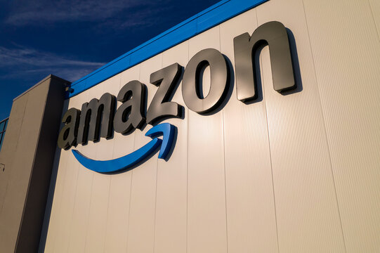 Toronto, Ontario, Canada - September 11, 2022:  Corporate Amazon logo brand name and trademark on the office building and Fulfillment warehouse entrance. Company developed international e-commerce.