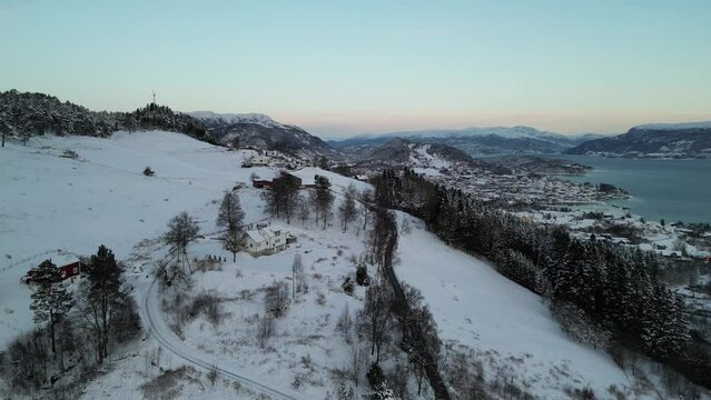 Sunset over Norwegian coastal landscape. Winter, mountains and fjord.