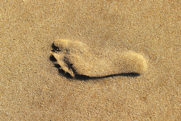Fototapeta na wymiar footprint in the sand optical illusion background
