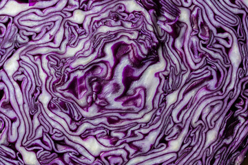 Obraz premium Background of blue cabbage in a section, macro photography. Closeup, top view. Texture and pattern of raw purple cabbage