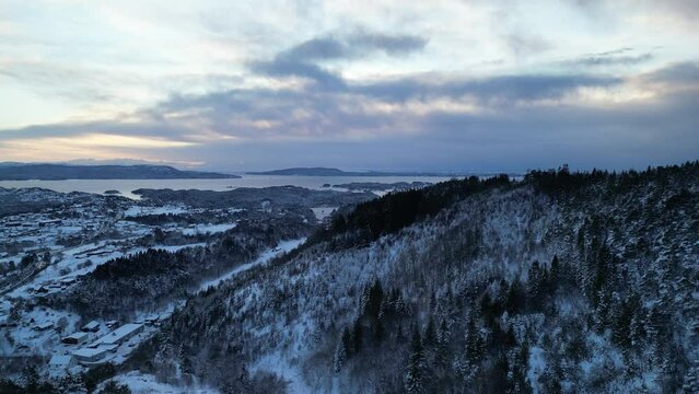 Sunset over Norwegian coastal landscape. Winter, mountains and fjord.