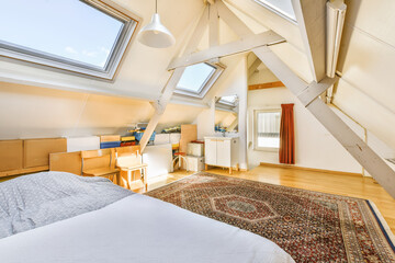 a bed in a room with skylights on the ceiling and an area rug under it that has been used for...