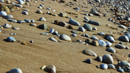 Fototapeta na wymiar pebble sand on the beach texture of stones and sand background