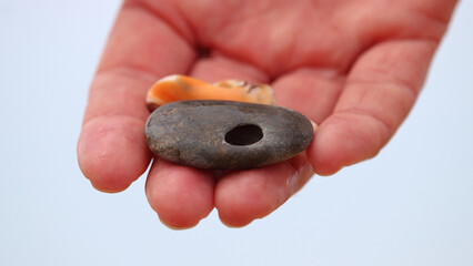 pebble with a hole in the palm close-up