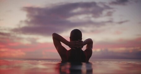 Close up of beautiful woman emerging from the water of luxury resort pool at sunset, relaxing health and wellness spa vacation - Powered by Adobe